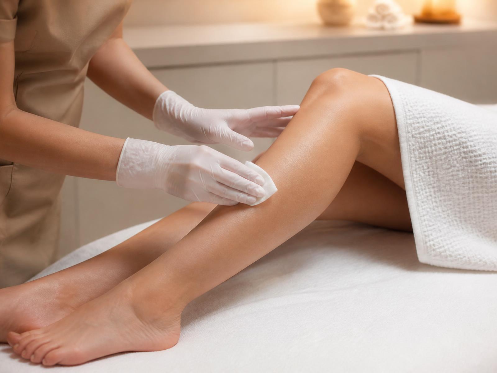Clinician preparing a woman's lower leg for treatment