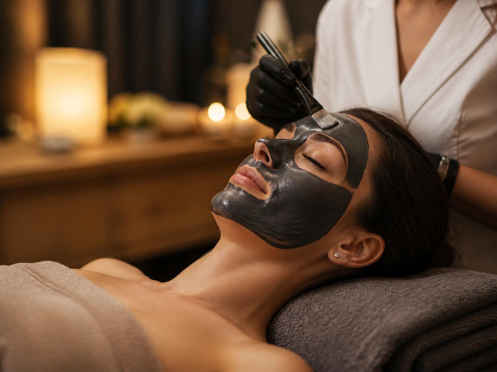 Clinician applying a charcoal facial mask
